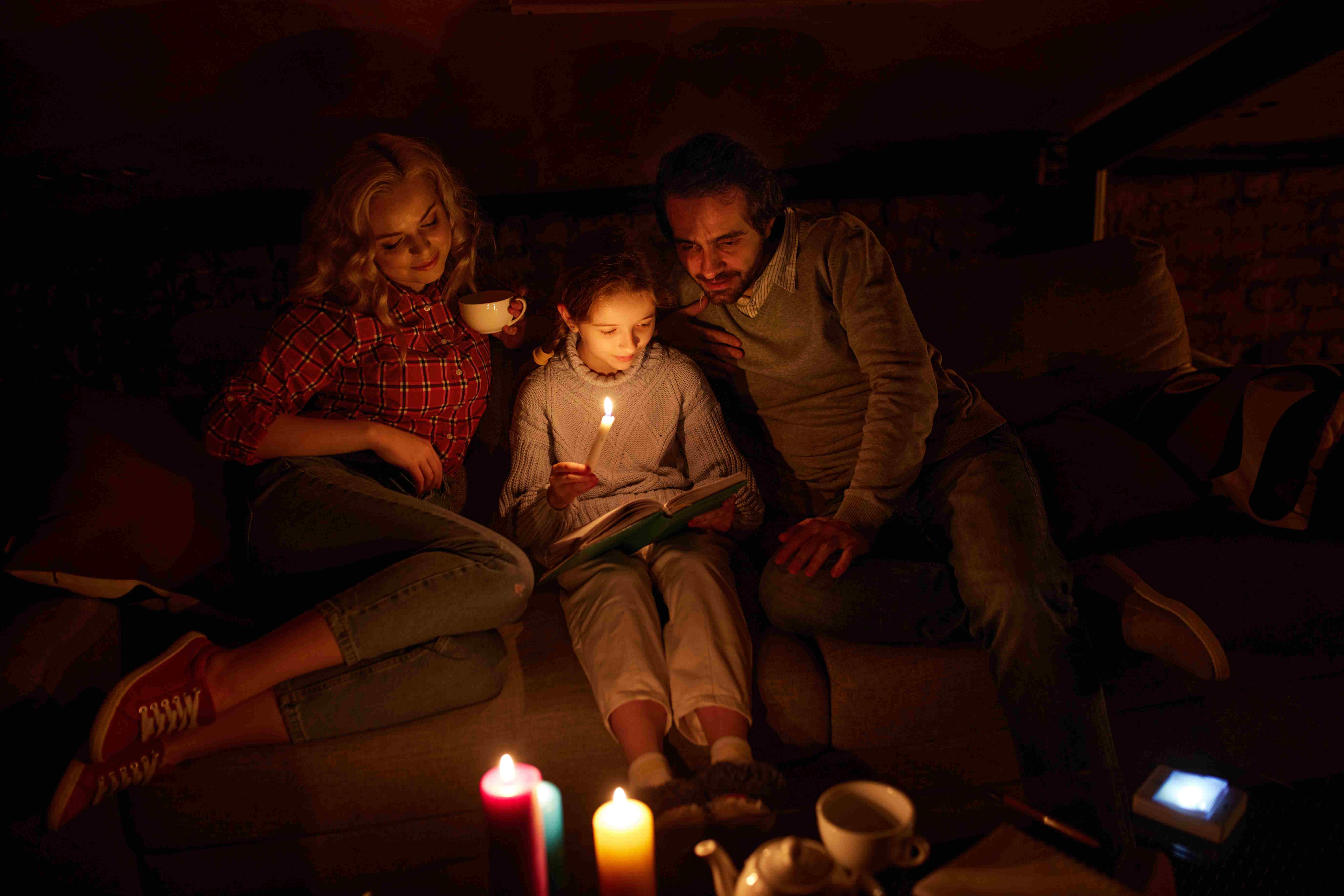 Family with candles during power outage